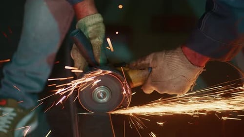 Gloved Man Cutting Metal With Grinder Sparks Flying