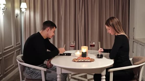 Couple Enjoying Romantic Candlelit Sushi Dinner at Home
