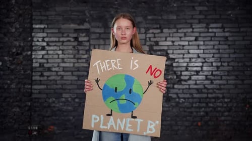 Young Adult Holding "There is No Planet B" Sign