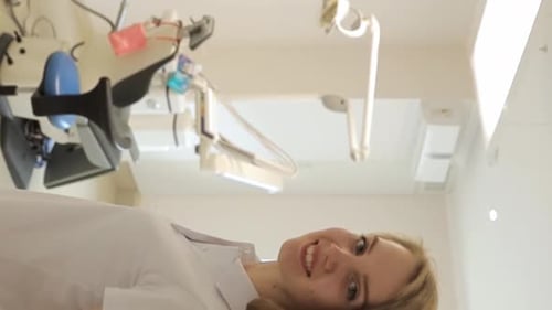 A Female Dentist Enters Her Office and Smiles Dentistry Beautiful Smile Vertical Video
