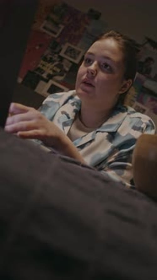 Woman Working on Laptop at Night in Bedroom