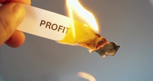 Burning paper with word profit