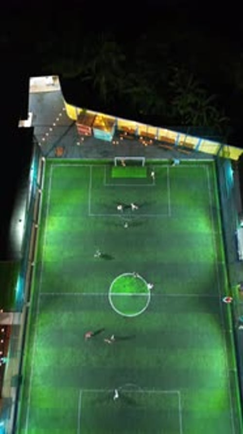 Vertical Drone Footage of mini football match, soccer. MiniFootball field and Footballers from drone