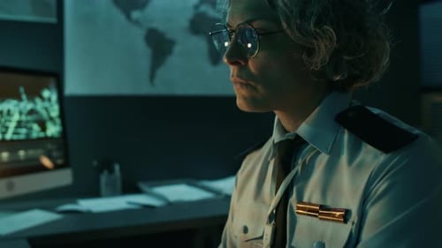 Woman Typing at Desk in Dark Office at Night