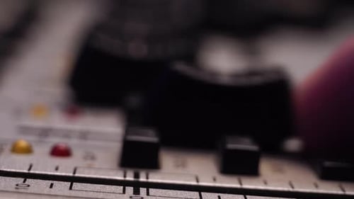 Moving Level Faders Up on Mixing Console Channels, Close Up