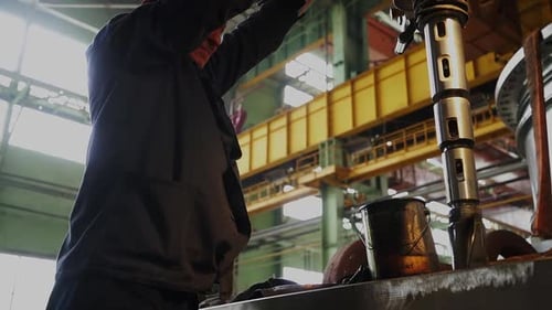 Industrial Worker Operating Heavy Machinery in Factory Stock Clip