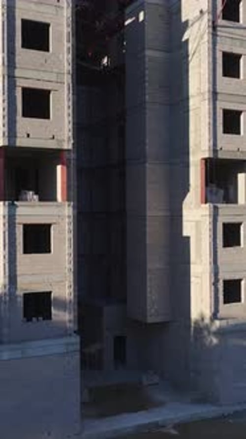 Vertical Video of an Urban Construction Site Captured From Above Showing Cranes Trucks and Ongoing