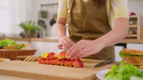 Close up of woman cooking healthy foods in kitchen in morning at home.