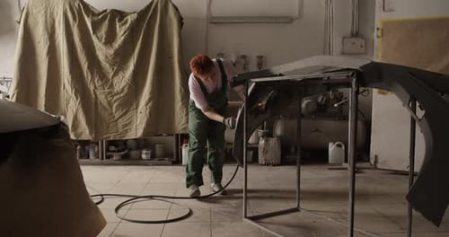 Female Painter Working in Sunlit Garage