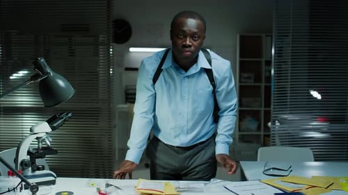 Man Examining Evidence in Brightly Lit Office