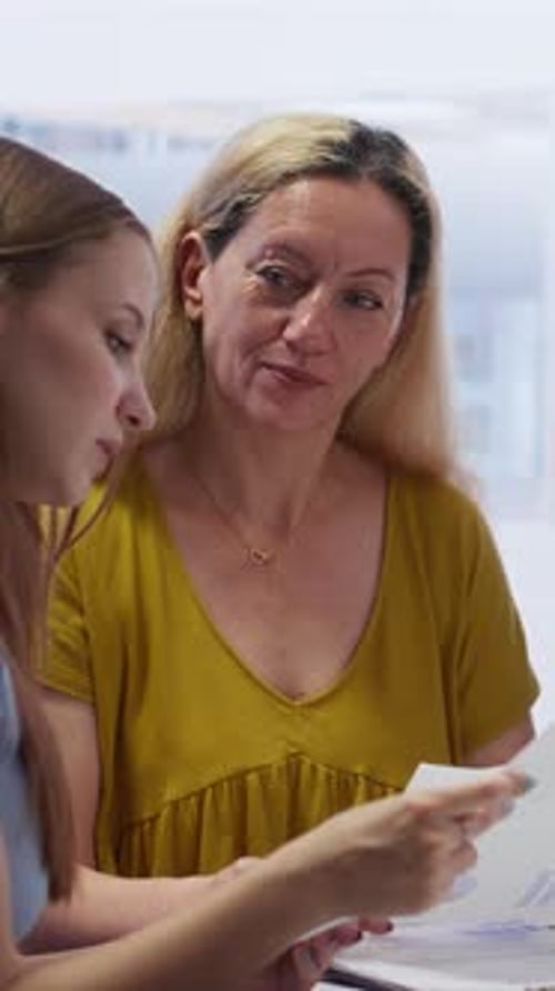 Vertical Video Consultant in Office Assisting People in Setting Up Living Expenses Plan