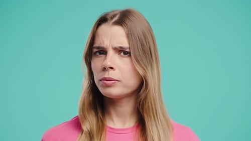 Young Woman Looking Surprised in Studio