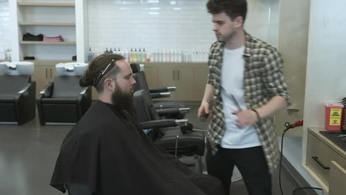 Man Gets Haircut and Beard Trim at Barbershop
