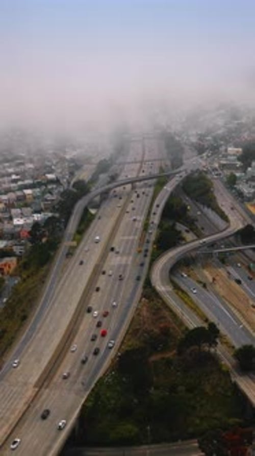Big city panorama covered with thick fog at daytime.