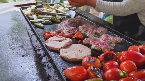 Person prepares Mexican food on the grill