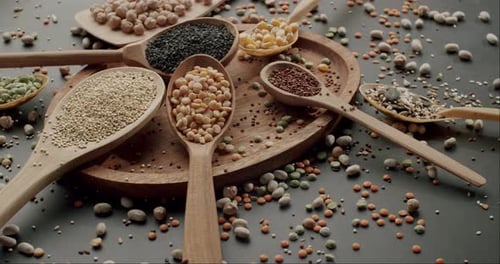 Wooden Spoons Filled with Grains, Seeds, and Lentils