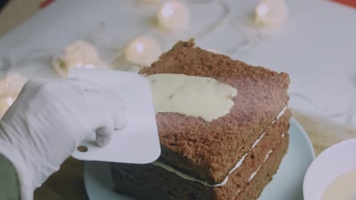 I Spread the Cream on the Square Cake Crust Christmas Atmosphere with Lights in the Background