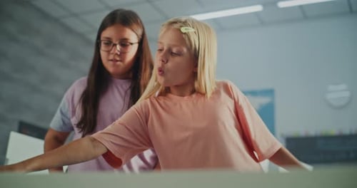 Two Girls Working Together on School Project