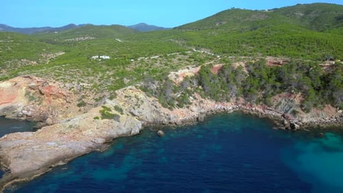 Rocky coast of Ibiza island, deep blue sea. Great aerial view flight drone