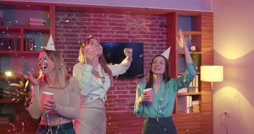 Female Friends in Party Hats Celebrating Birthday