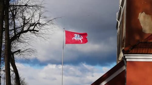 Establishing Shot of Building and Waving Red Flag