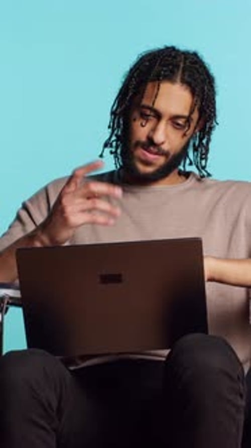 Vertical Video Man in Wheelchair Chatting with Friend Over Internet Videocall Using Laptop