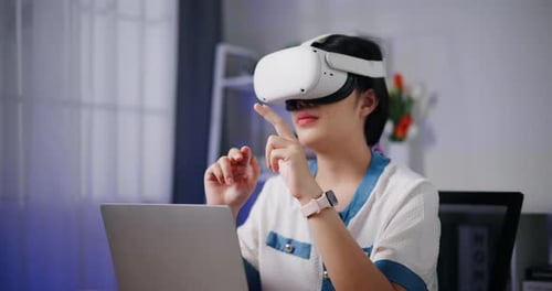 Woman Using VR Headset and Laptop in Office