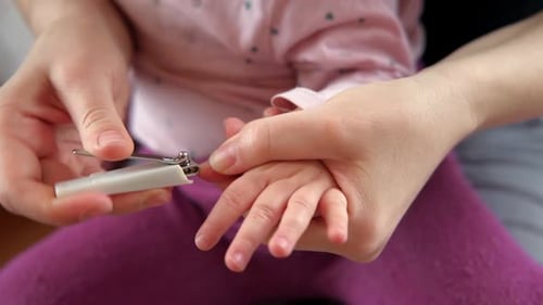 Parent Clipping Baby's Fingernails at Home