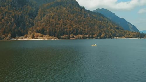 Two People Paddling a Kayak on an Apline Lake with Mountains in the Background, Active Lifestyle Con