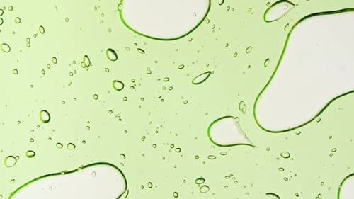 Transparent Green Cosmetic Gel Fluid With Molecule Bubbles and Oil on White Background