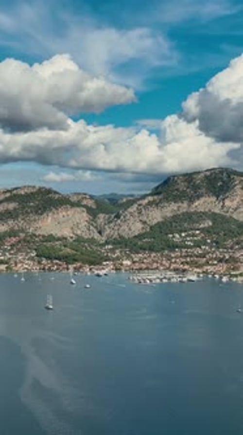 Vertical aerial of turquoise sea and sandy shore