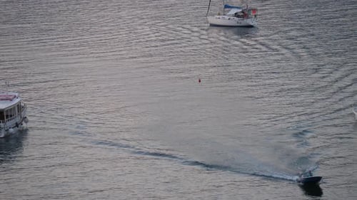 Blue Motorboat Speeding Across Calm Water