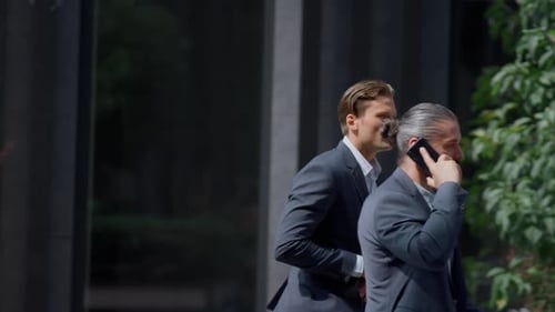 Serious businessman running late for important meeting in modern city center