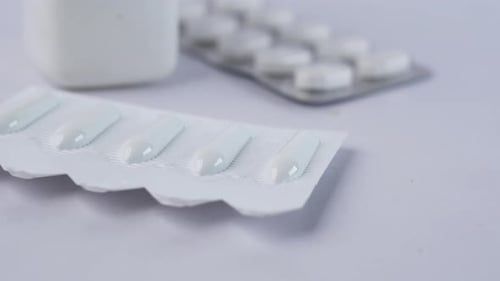 Close up of White Medical Pills and Capsules