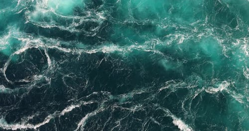 Blue waves of water of the river and the sea meet each other during high tide and low tide.