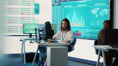 Business Specialist Reviewing Key Performance Indicators Within Firm Activity