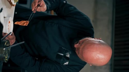Chef Prepares Gourmet Sandwich with Tongs