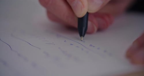 Closeup of Male Entrepreneur Writing Strategy on Paper