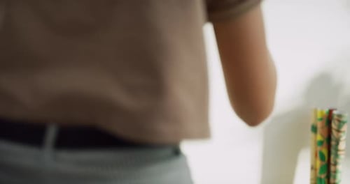 Curious woman holds up earrings for friend in boutique clothing store