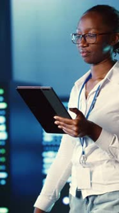 Vertical Video Woman Walks Through Data Center Systems