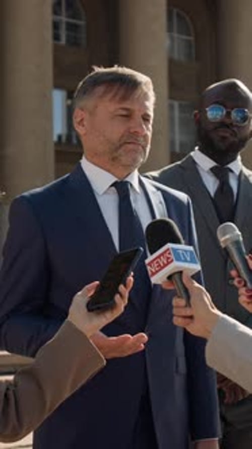 Vertical of Male Barrister Giving Interview to Mass Media after Court Trial