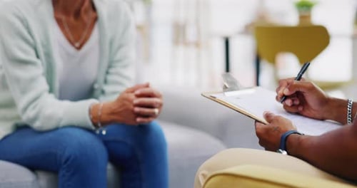 Woman Talking with Counselor in Bright Room