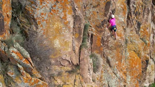 Man Athlete Climbing on the High Rock