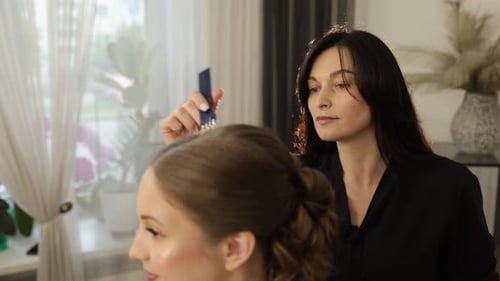 Hairdresser Creates Hairstyle for Young Woman Indoors