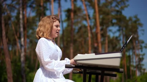 Side View Talented Thoughtful Caucasian Girl Singing Playing Piano Synthesizer at Background of