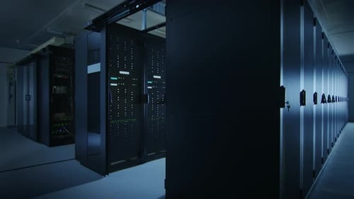 Camera Slide-Trough Shot of a Working Data Center With Rows of Rack Servers. Led Lights Blinking an