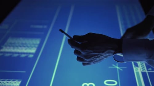 Man Hands with a Watch and Pencil Move and Remove Blueprint From a Large Touchscreen