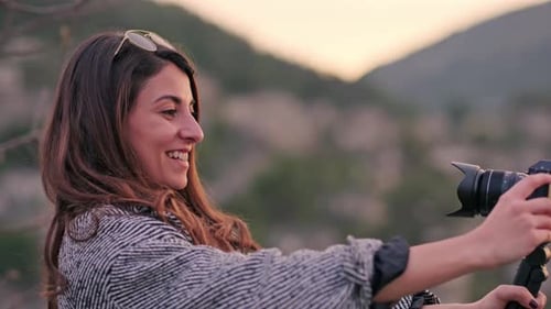 Smiling Vlogger Filming with a Handheld Camera