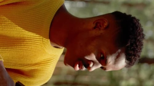 African American Man Using Smartphone in the Forest