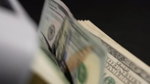 Money Counter Counts Stacks of Hundred Dollar Bills
